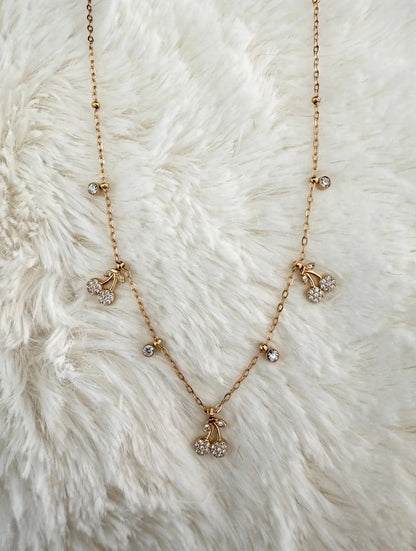 Cherry Charm Necklace on white fur background
