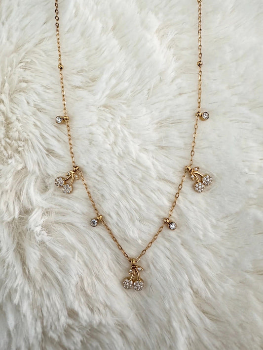 Cherry Charm Necklace on white fur background