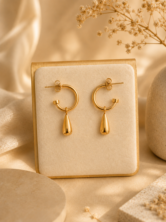Gold teardrop hoop earrings on display